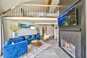 The 3rd floor loft overlooks the living room with high vaulted ceilings