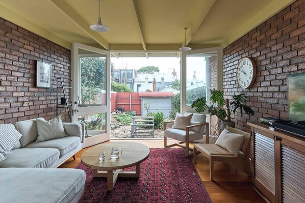 The sunroom comes with a TV for your entertainment and opens to the backyard.