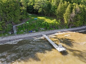 View of the 200 feet of private Green Bay shoreline and seasonally installed dock