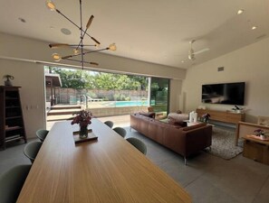 Oversized high-end all wood dining table in open concept space