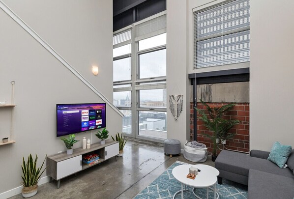 Main living space with sectional sleeper sofa and 50" Smart TV