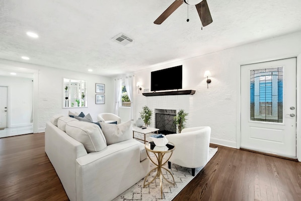 Relax in the inviting living room featuring a plush sofa and a smart TV