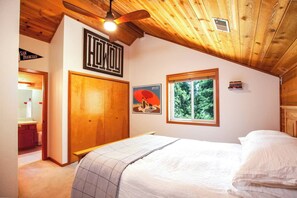 Ample storage and cozy linens in the upstairs queen bedroom. 