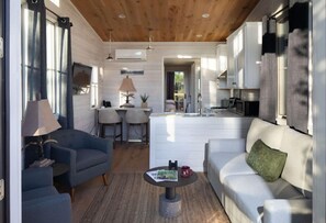 Relax in the open living area, boasting contemporary decor and a seamless blend of indoor and outdoor living spaces.