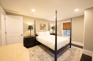 Relax in this inviting bedroom featuring a classic four-poster bed and warm, soothing decor.