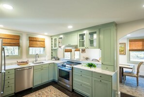 Cook up delicious meals in this modern kitchen, featuring plenty of natural light and all the amenities you need.