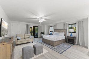 Rest easy on a plush king bed with cozy linens, perfect for recharging after a day by the sea.