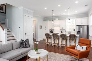 Spacious open-concept kitchen and living area with modern amenities and cozy seating.