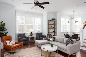 Bright and airy living room with ample seating and natural light for a cozy gathering.