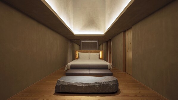 [SOKI Suite] 66m² / bed width 1,800mm. Equipped with a sofa and a stone table.