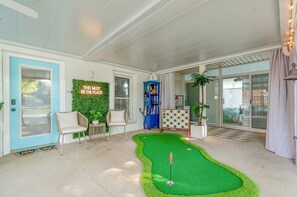 Your backyard space is designed for both relaxation and fun, with a mini golf putting green, comfortable seating, and a breathtaking view of the lake for everyone to enjoy.