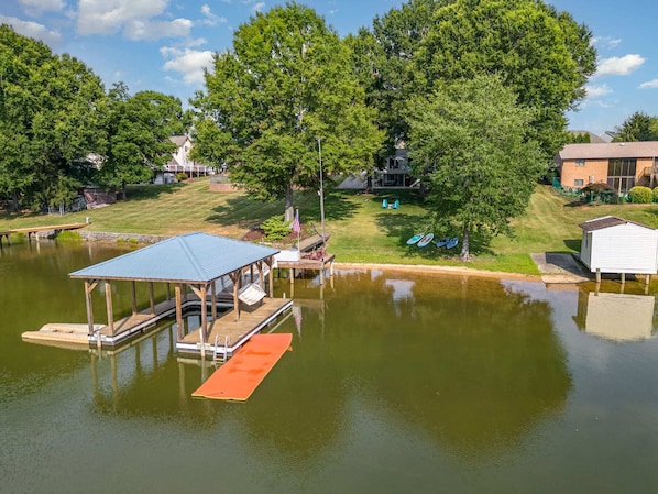 Experience the ultimate lake adventure with direct access to a private dock, kayaks, paddle boards, and an XL splash pad, all set against a stunning lakeside backdrop.