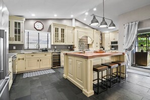 The fully stocked kitchen is perfect for cooking enthusiasts and a great place to hang out! 