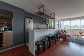 Experience urban living with a modern kitchen and cozy living area, all while enjoying breathtaking city views from your window.