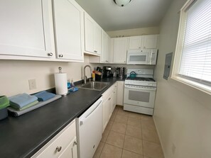 Full kitchen with a vented over the range microwave range vent. 