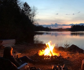 Fire pit and sunset over the pond.