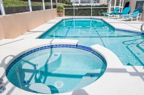 Relax and unwind in the private pool and spa under the sunny sky.