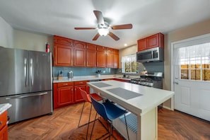 Updated kitchen with stainless steel appliances, island, and plenty of storage and counter space