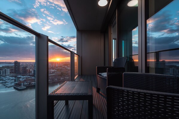 Large balcony with table and seating to enjoy a drink or meal with breathtaking views.