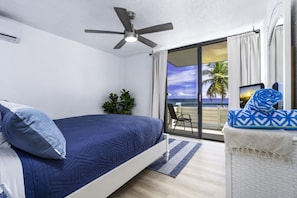 The primary bedroom with a queen bed and balcony access!