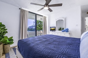 The primary bedroom with a queen bed and balcony access!