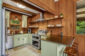 Open Kitchen with Granite Countertops and Bar Seating for Two