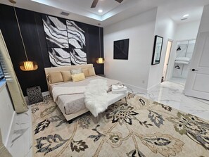 Large open master with king bed and en suite bathroom with separate shower/tub