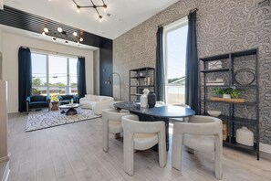 1st Floor: Open-concept living space seamlessly flows the living room, dining area, and kitchen into one. The dining table comfortably accommodates up to six guests.
