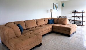 Large bright living room with comfy couch
