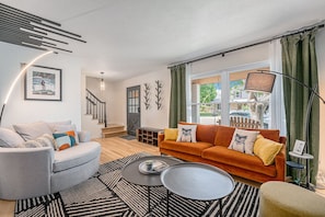 Step into this inviting living space just off the entryway. Featuring stylish decor, comfortable seating, and warm lighting, it's the perfect place to relax and welcome guests to your home away from home.