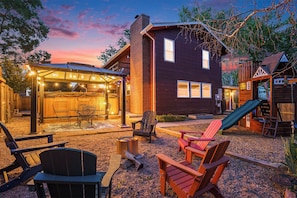 The backyard sparkles enchantingly at night, illuminated by a dazzling array of lights that add a magical touch to the outdoor space.