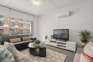 A cozy living area with a TWO 3-seater sofa beds that folds out to doubles.