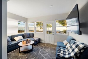 Cozy living room with a patio door opening onto a balcony, ideal for enjoying morning coffee or evening sunsets.