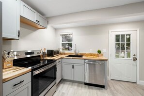 Modern kitchen with ample counter space, complete with a range of appliances and utensils, ideal for preparing delicious meals.