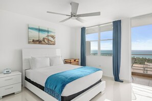 The master bedroom features a king bed, a balcony with views, flat screen TV and ensuite bathroom.