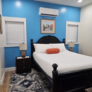 Queen bedroom with tv