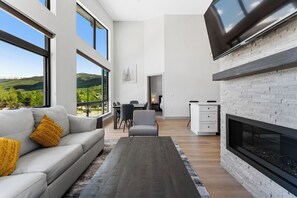 Spacious living area with mounted smart TV and gas fireplace.