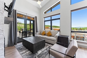Spacious living area with mounted smart TV and gas fireplace.