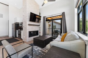 Spacious living area with mounted smart TV and gas fireplace.