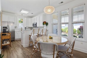Spacious dining area with table and breakfast bar 