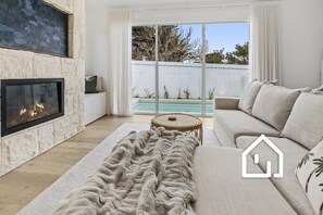 A cosy lounge room with electric fireplace, perfect over the winter months