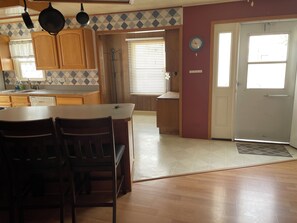 View from the dining room looking at front door, small office space, and kitchen