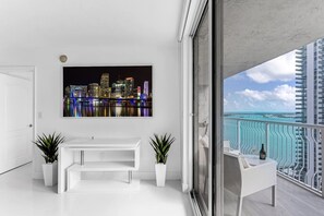 Living room view. The table under the smart TV converts into a functional desk for remote work.