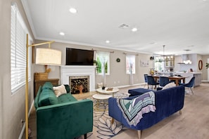 Combine modern entertainment with vintage charm in our living room featuring a smart TV and record player.