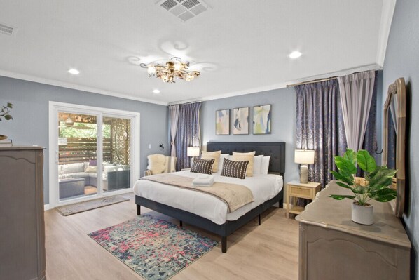 Unwind in a Comfortable King Bed with Patio Access and a Cozy Lounge Chair