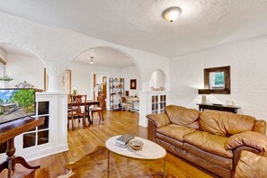 ️ Charming Spanish Revival arches open into the dining room, blending vintage character with a breez