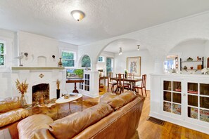 Unwind in the cozy heart of the home—plush leather seating, warm textures, and a historic fireplace