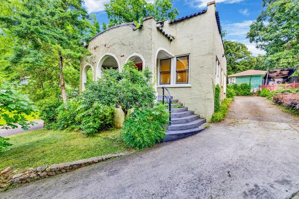This isn’t your average front door—make your entrance through classic architecture and garden-lined 