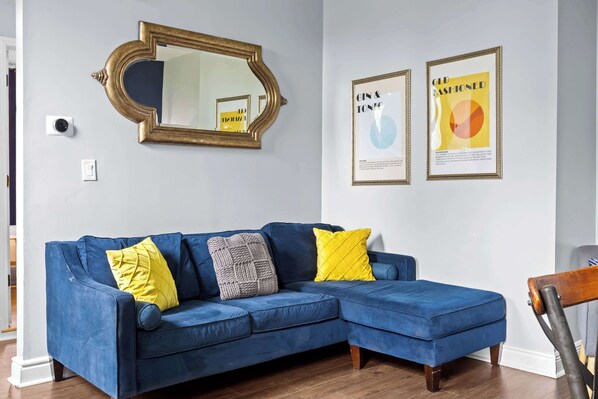 Living Room: Chic, comfortable, and filled with natural light — the perfect space to unwind or catch up on your favorite shows
