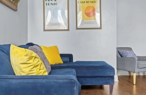 Living Room: Chic, comfortable, and filled with natural light — the perfect space to unwind or catch up on your favorite shows